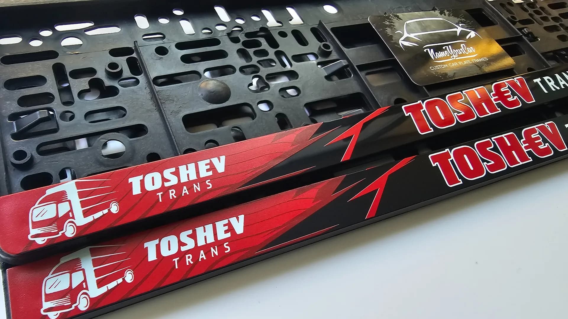 Toshev Trans advertising license plate frame with company logo in red and UV print from nameyourcar.store