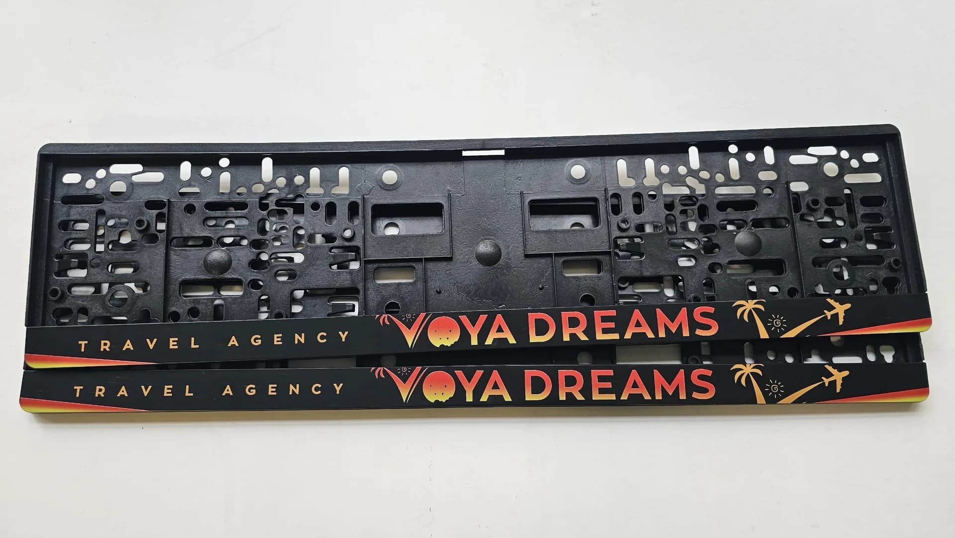 Company license plate frames with the text Voya Dreams — advertising frames for business from NameYourCar.store
