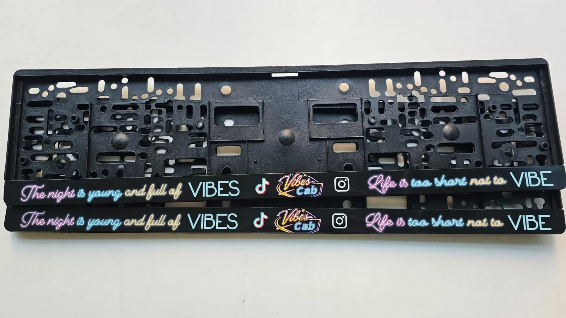 Advertising license plate frame with the text Vibe Cab — personalized UV print from NameYourCar.store
