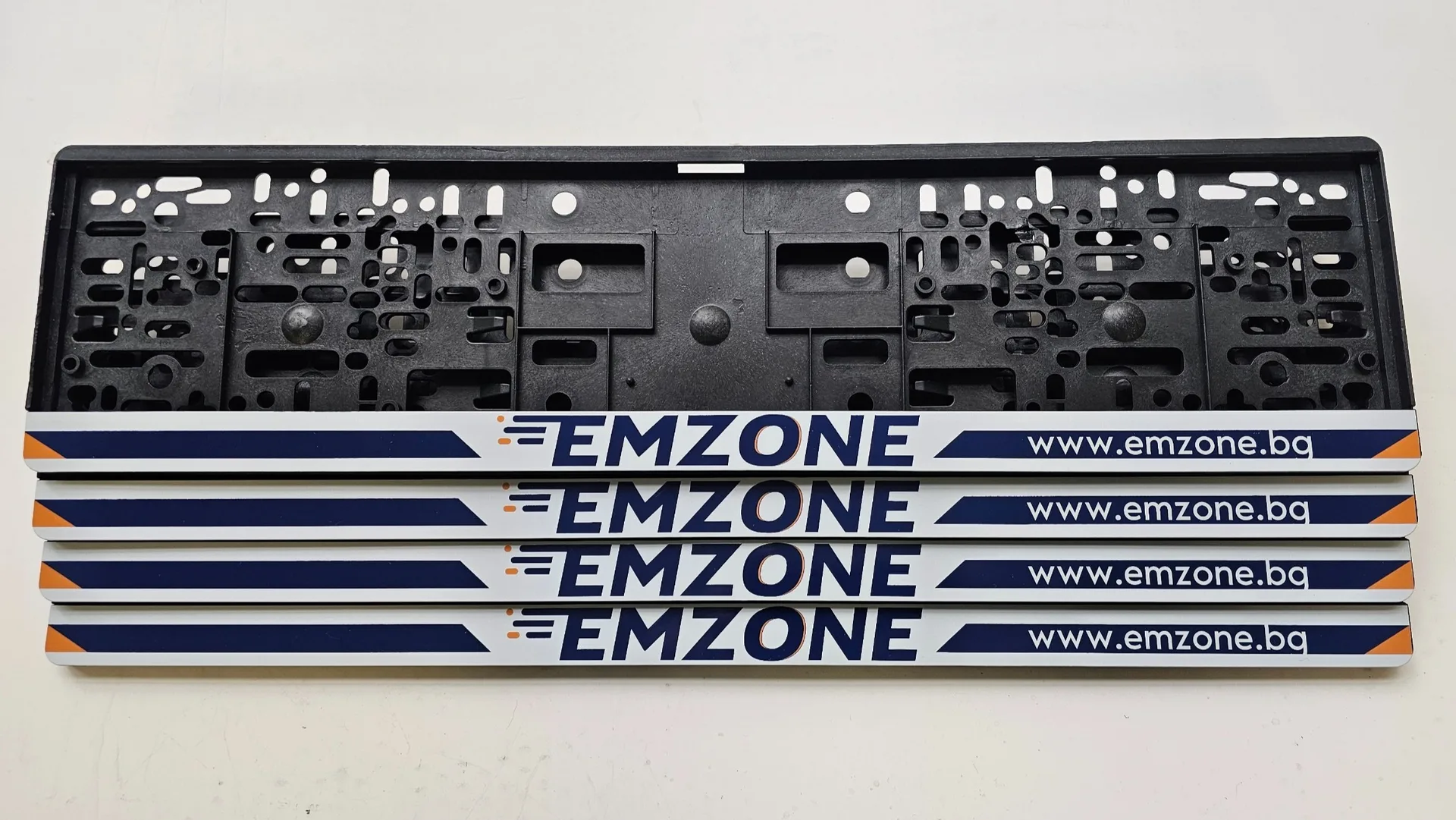 EMZONE advertising license plate frames with UV print and the business website — personalized by NameYourCar.store