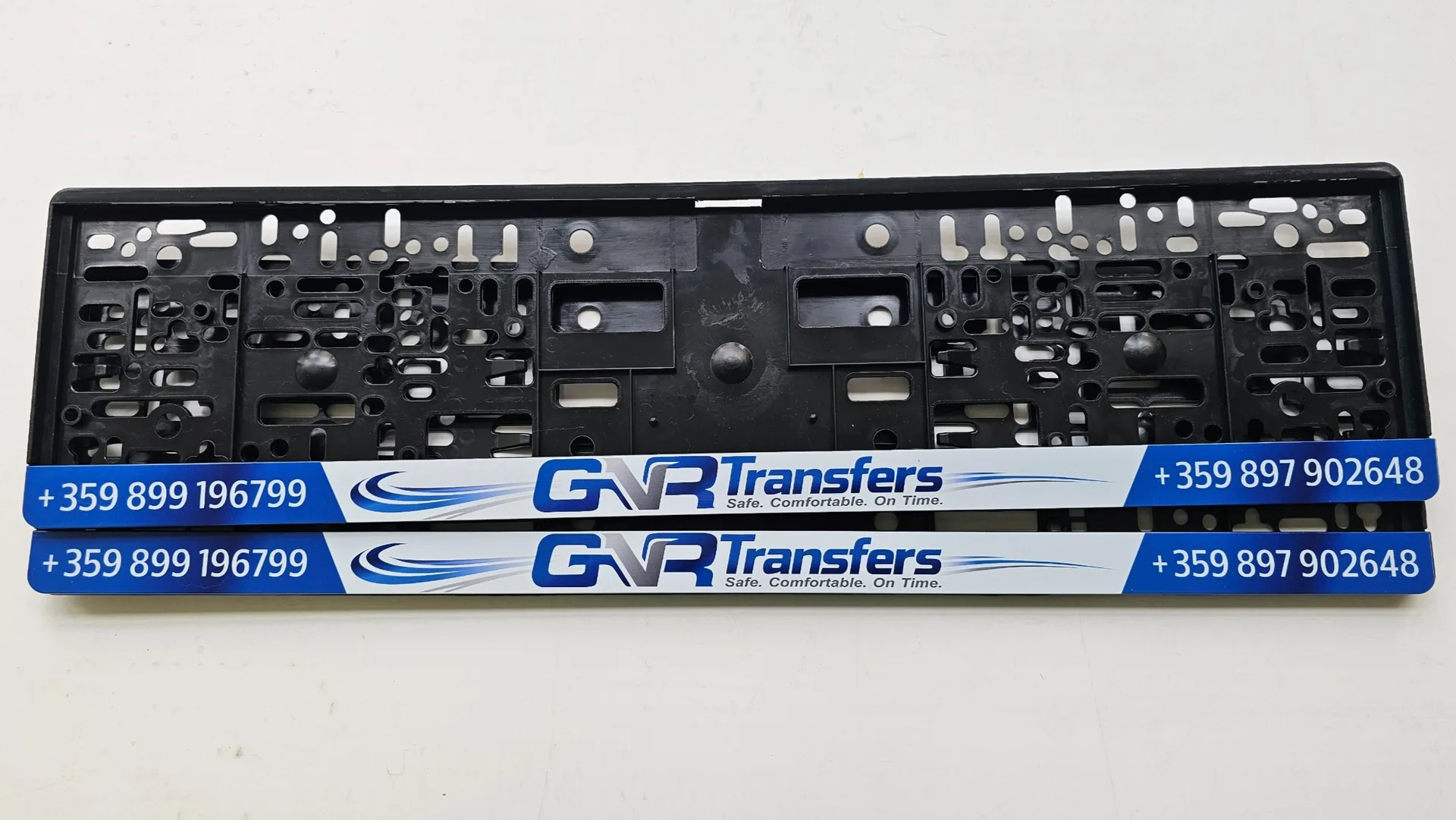 Advertising license plate frame with the text GNR Transfers, logo and contact phone — personalized business frame with UV print