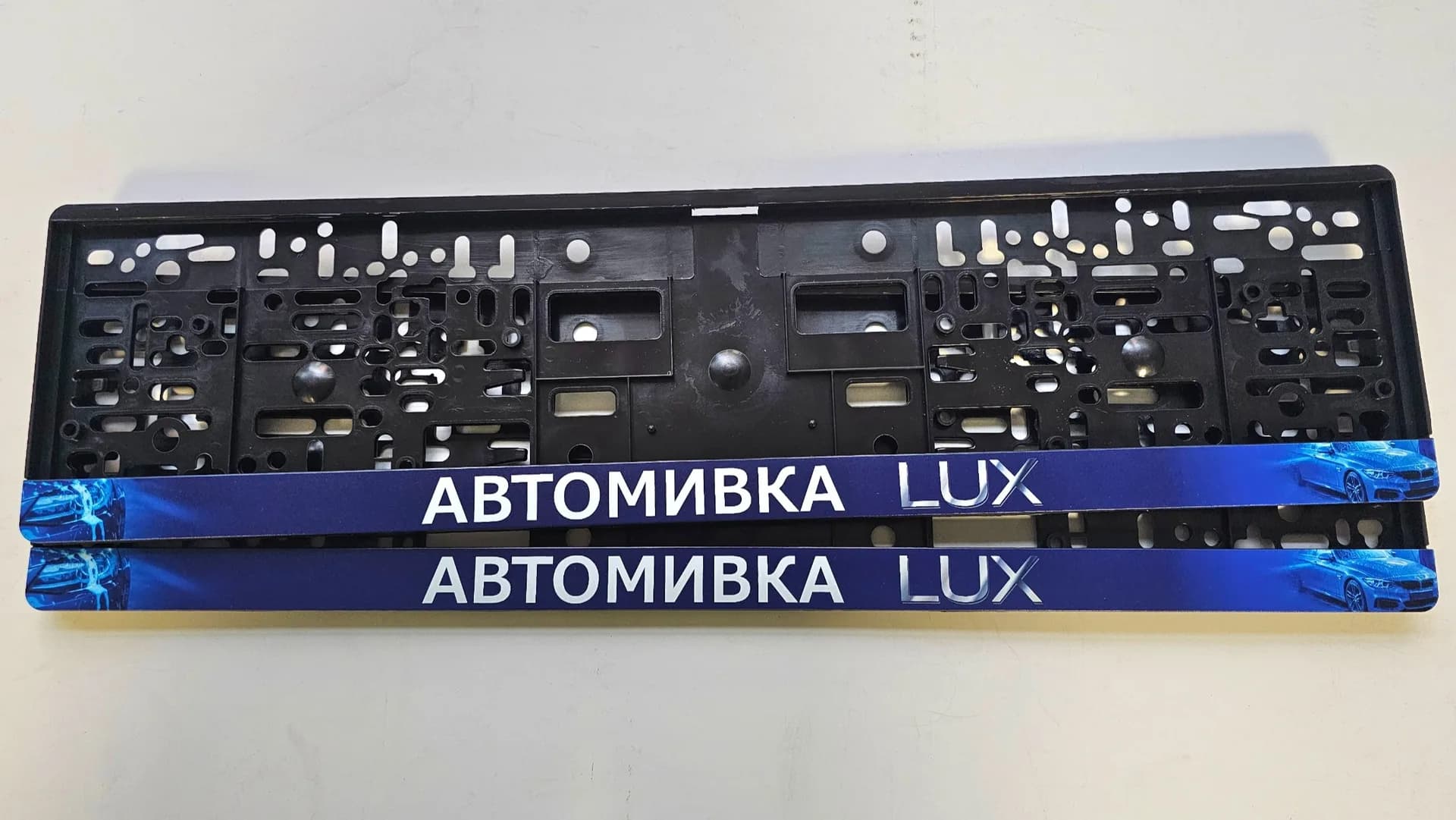 Advertising license plate frame with the text LUX car wash and full background with UV print from NameYourCar