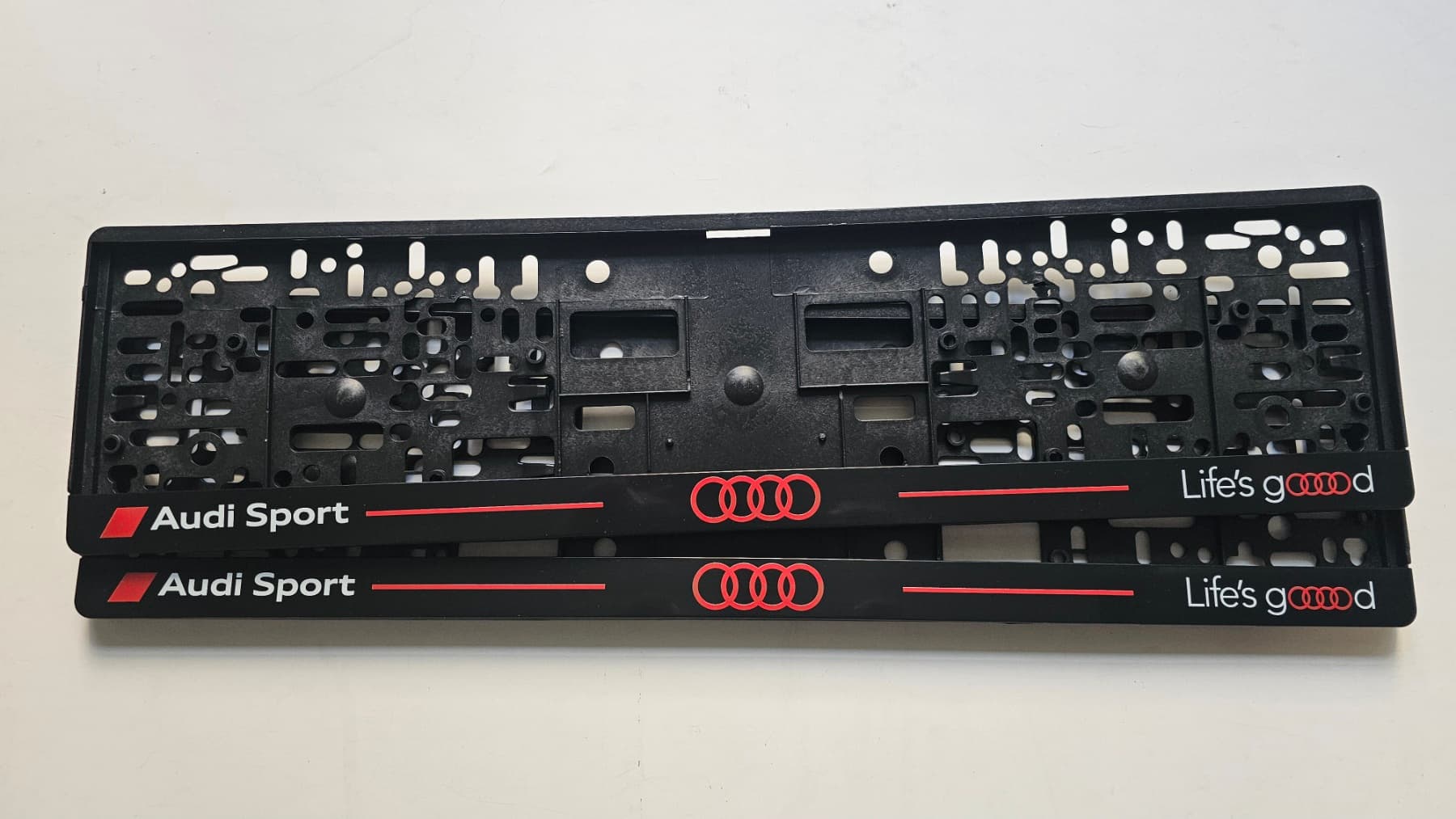 Audi Sport and Life's Good license plate frame — UV printing, studio photo